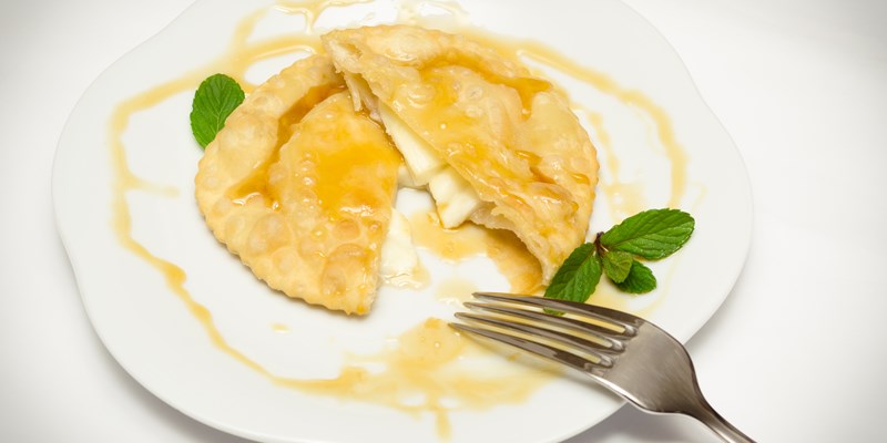 Sebada, traditional dessert made in Sardegna, stuffed with cheese and topped with honey