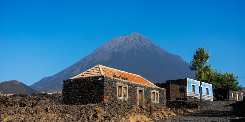 Cabo Verde, Pico do Fogo, Caldera. Volcano Pico do Fogo, 2829 m, the highest mountain of Cabo Verde standing isolated in the burned Lava fields. Hauses of igneous rocks in the Cha das Caldeiras.