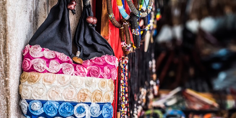 handmade fabric bag hung on a wall for sale in african market street