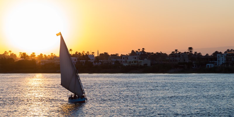 Tourist sailboat at Luxor waterfront during sunset. - Image