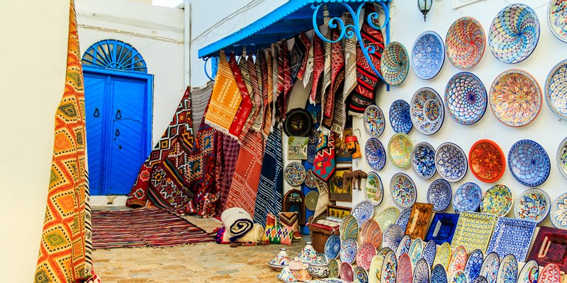 Souvenir earthenware and carpets in tunisian market, Sidi Bou Said, Tunisia. - Image